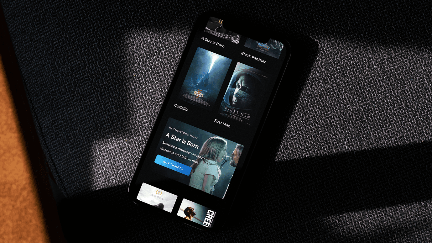 Atom Tickets app · movie discovery and seat selection on the phone