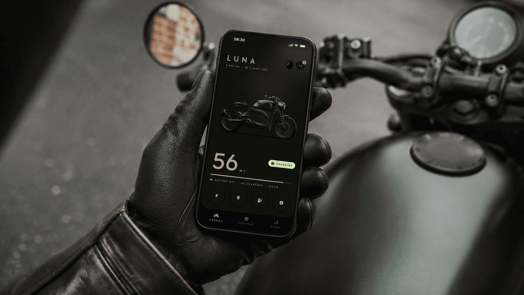 Rider holding the Tarform iPhone app on the bike